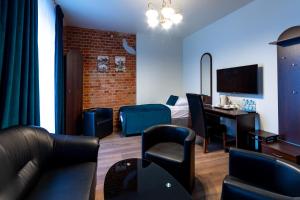a hotel room with a bed and a table and chairs at Apart Podolski in Sandomierz +73 photos