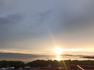 a view of the sun setting over a body of water at Montecarlo Townhouse Residences in Masbate +9 photos