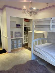 a bedroom with a bunk bed and a chandelier at Private Room View Pool Big Estate Oasis Extra Fee 4 Guest Clea-ning Pet WOMEN ONLY in Encino