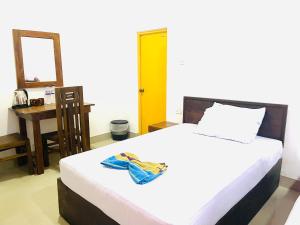 Voodi või voodid majutusasutuse Sigiriya River Side Resort toas