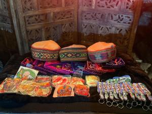 a group of hats and other items on a table at Aura Manali Best Mountain View Stays in Vashisht