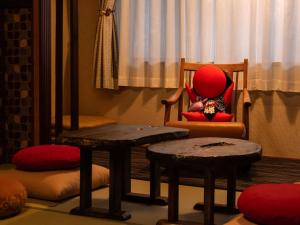 a child sitting in a chair in a room at Ryokan Gizan in Takayama
