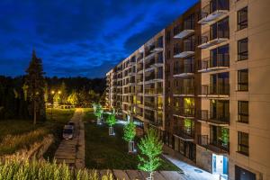 an apartment building at night with christmas lights at River Side Residence in Oświęcim