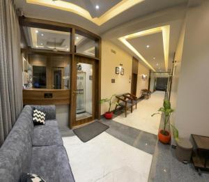 a living room with a couch and a table at Hotel Sundarai Lodging in Jāmkhed