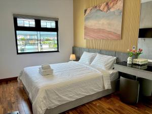 Postel nebo postele na pokoji v ubytování CEVA Hotel & Apartment Danang