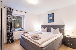 a bedroom with a large bed and a window at Fewo Zur Piste in Willingen