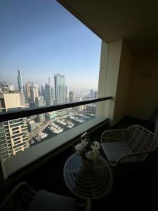 a balcony with a table and chairs and a view of a city at Best view homes in Dubai
