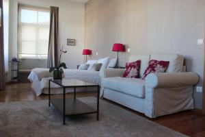 a living room with two couches and a coffee table at Domus 26 Guesthouse - B&B in Braga