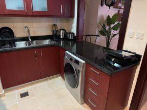 a kitchen with a sink and a washing machine at Best view homes in Dubai +12 photos