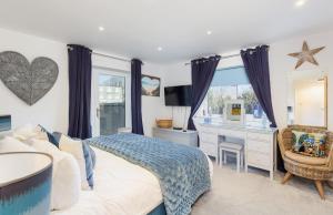 een slaapkamer met een bed en een bureau met een computer bij Sun Rise in Sandown