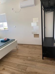 a room with a bed and a wooden floor at מעבר לקשת in Keshet +23 photos