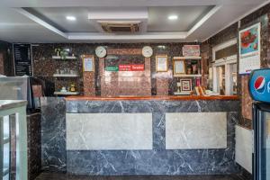 a bar in a restaurant with a marble counter at OYO 825 Hotel Baikuntha in Kathmandu