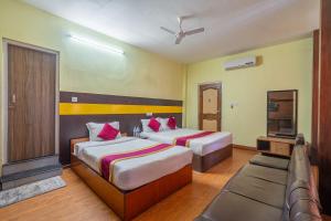 a hotel room with two beds and a couch at OYO 825 Hotel Baikuntha in Kathmandu +30 photos