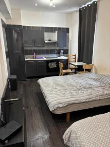 a hotel room with two beds and a kitchen at Studio 301 vieux port opéra in Marseille