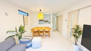 a living room with a table and chairs and a couch at Ireach Nago Okinawa in Nago +34 photos