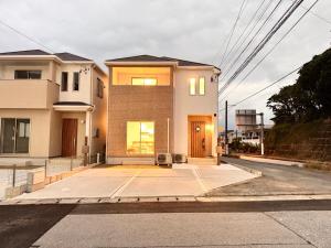 a house on a street with a driveway at Ireach Nago Okinawa in Nago