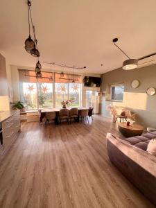a large living room with a table and a couch at Zeltāres in Jelgava +67 photos