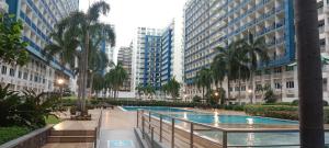 a swimming pool in a city with tall buildings at Home style Staycation in Manila