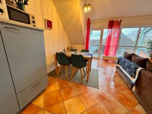 a kitchen and living room with a table and chairs at Maisonette am See in Seedorf