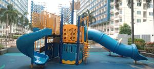 a playground with a slide in a city at Home style Staycation in Manila
