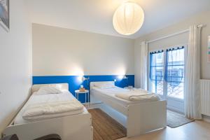 a bedroom with two beds and a window at Les dunes maison deux chambres in Les Sables-dʼOlonne