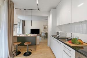 a kitchen with white cabinets and a counter top at Novos Contrada in Lugano