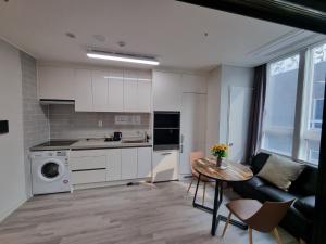 a kitchen and living room with a table and a counter at Yangju Sky Castle in Yangju