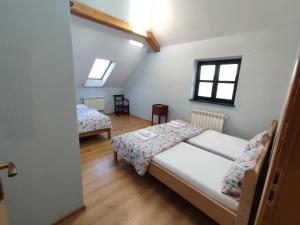 a room with two beds and two windows at Roztoczańska Posiadłość in Lipsko-Polesie