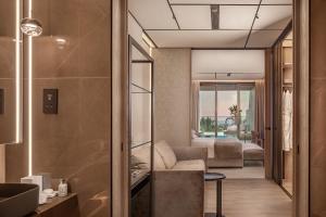 a living room with a couch and a bedroom at Amathus Beach Hotel Limassol in Limassol