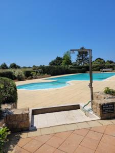 a swimming pool with a sign in front of it at T2 L'orée du Golf labellisé 3 étoiles - Terasse et Parking in Pornic