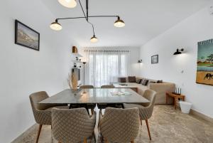 a dining room and living room with a table and chairs at Sunny Cairo City Center l Serviced l Golf l Pool l Gym l 1 in Cairo