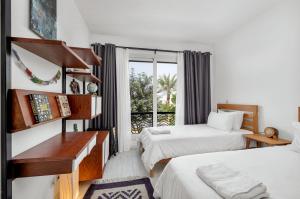 a hotel room with two beds and a window at Sunny Cairo City Center l Serviced l Golf l Pool l Gym l 1 in Cairo