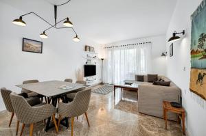 a living room with a table and chairs and a couch at Sunny Cairo City Center l Serviced l Golf l Pool l Gym l 1 in Cairo