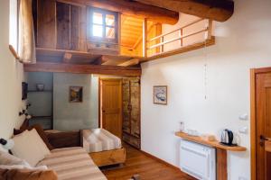 a living room with a couch and wooden ceilings at Agriturismo LO PUY in San Damiano Macra
