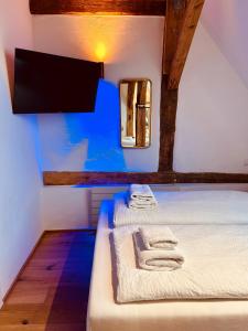 two beds in a room with blue lighting at Family Apartments Abuja in Rust +123 photos