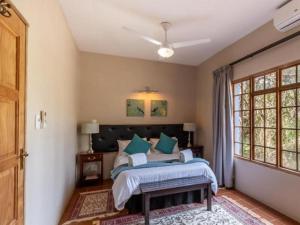 a bedroom with a bed and a window at Ndumu Safari Resorts in Jozini +14 photos
