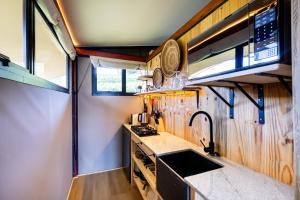 a kitchen with a sink and a counter top at Amperbo Glamping in Cape Town +27 photos