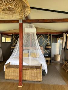 a bedroom with a bed with a net at Amperbo Glamping in Cape Town