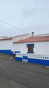 a blue and white building with a window at Zena Houses-Casa Rural tranquila perto de Mértola in Beja