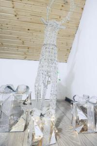 a metal sculpture of a deer in a room at Rustik pub in Lupeni +33 photos