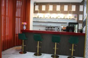 a bar with green bar stools in a restaurant at Cromwell Hotel in London