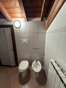 a bathroom with a toilet and a sink at Dante 10 Flat in Cremona
