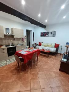a kitchen and living room with a table and a couch at La casa del Borgo Anagni in Anagni