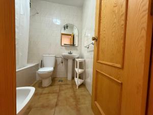 a bathroom with a toilet and a sink and a tub at Marco Polo by Alina365 in La Manga del Mar Menor +45 photos