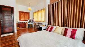 Postel nebo postele na pokoji v ubytování Baan Bhuwann Holiday Apartment