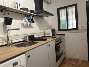 a kitchen with a sink and a counter top at Veratha House in Candeleda