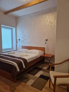 Postel nebo postele na pokoji v ubytování Apartmány Aurelius