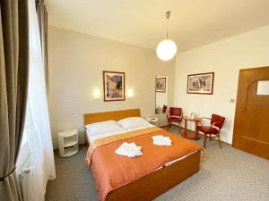 Postel nebo postele na pokoji v ubytování Apartmány Aurelius
