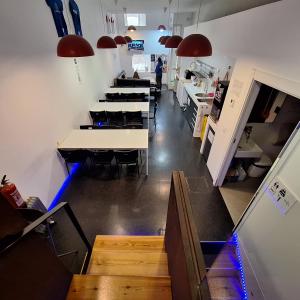 a restaurant with tables and chairs in a room at Hostel Casa Ibarrola in Pamplona +17 photos