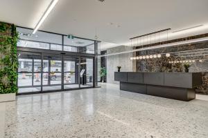 a lobby of a building with a reception desk at Appartements Dorchester in Montreal +83 photos